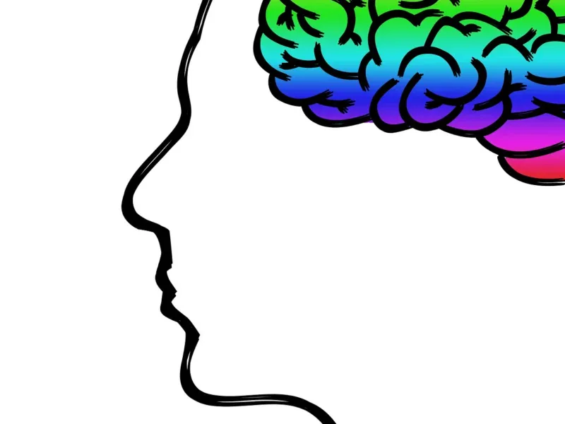 Sylwetka głowy z mózgiem w kolorach tęczy — symbol neuroróżnorodności